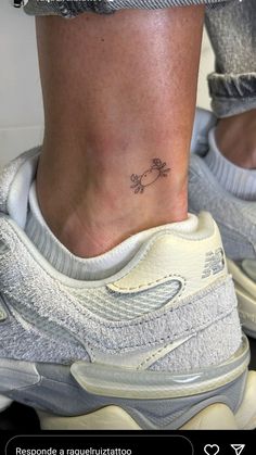 a person with a small flower tattoo on their ankle and the bottom part of her foot