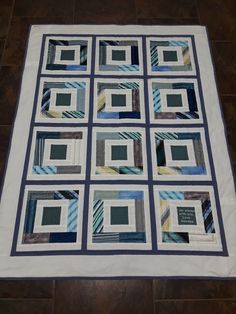 a blue and white quilt is on the floor