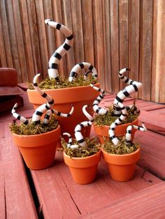 there are many black and white dalmatian figurines in the flower pots