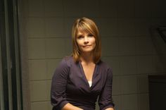 a woman sitting on top of a chair in a room