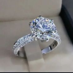 an engagement ring in a box with diamonds on it