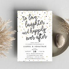 a white and gold wedding card with confetti on it