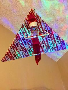 the elf is hanging upside down on the ceiling