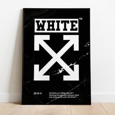 a black and white poster sitting on top of a wooden floor