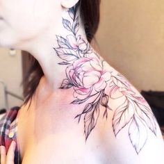 a woman with a flower tattoo on her neck