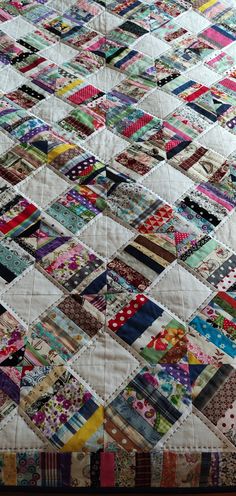 a quilt made with many different colored squares