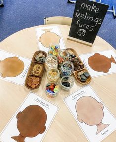 a wooden table topped with lots of cut out shapes and cards on top of it