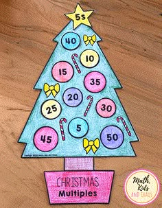 a christmas tree made out of colored paper with numbers on it and candy canes