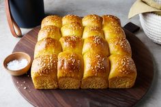 a loaf of bread sitting on top of a wooden cutting board