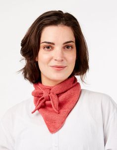 a woman wearing a red scarf and white shirt