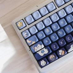 a keyboard with stickers on it sitting on a table