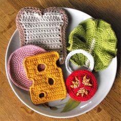 three crocheted items are on a plate