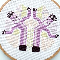 a cross stitch pattern on a wooden hoop