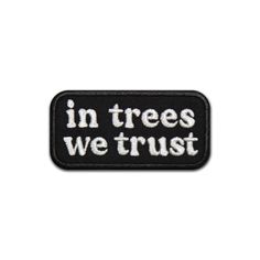 a black and white patch with the words in trees we trust