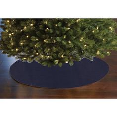 a christmas tree in a blue pot with white lights on the top and around it