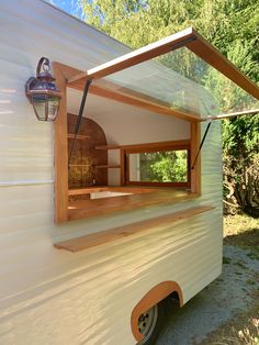 an old camper converted into a tiny house with a hot tub in the back