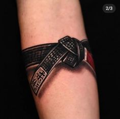 an arm with a tattoo on it that has a large knife in the middle of it