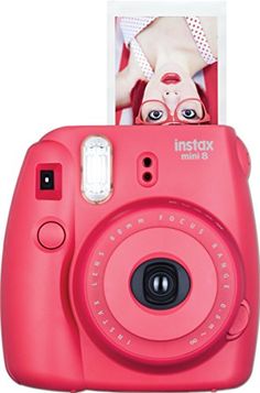 a pink camera with an instax card attached to it