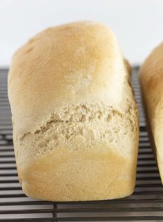 two loaves of bread sitting on top of a cooling rack