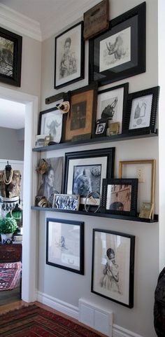 a wall filled with pictures and framed photos