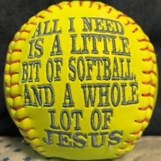 a yellow softball with words written on it