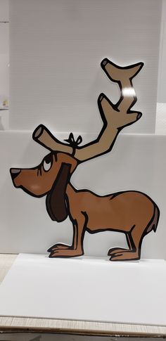 a cardboard cutout of a dog with antlers on it