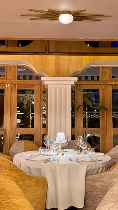 a dining room with white table cloths and chairs