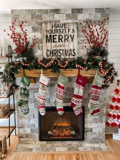 christmas stockings hanging on the mantle in front of a fireplace