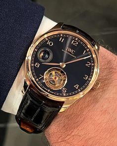 #watchesandwonders2024 The beautiful IWC Portugieser Hand-Wound Tourbillon Day & Night in Armor Gold with obsidian black lacquered dial on @santoniofficial alligator strap. The striking day & night indicator is a small gold/black sphere visible from both sides of the case. The 42.4 x 10.8 mm Armor Gold case houses the Calibre 81925, a manual winding movement featuring a one-minute flying tourbillon at 6 o’clock, 3D day/night at 9 and a 84-hour power reserve. 💰 USD 79,300 . O belíssimo IWC Por... Black And Gold Watch, Iwc Pilot, Hand Wound, Iwc Watches, High End Watches, Classic Watches, Day Night