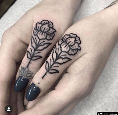 two hands with tattoos on them and one has a flower tattooed on the middle finger