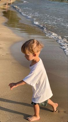 a little boy that is standing in the sand