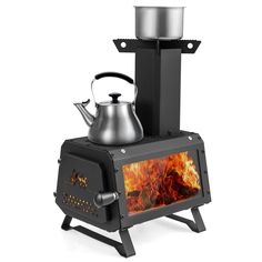 a stove with a kettle on top and fire burning in the oven next to it