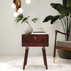 a living room with a chair, table and potted plant on the sideboard