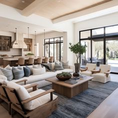 a living room filled with furniture and lots of windows