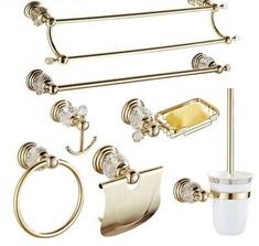 gold bathroom accessories including toilet paper holder, soap dispenser and towel rack