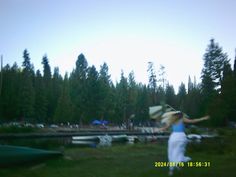 a blurry photo of a woman playing with a frisbee