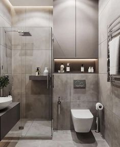 a bathroom with a toilet, sink, and shower stall in it's corner