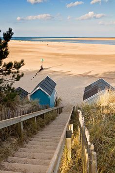 stairs lead down to the beach with lifeguard huts