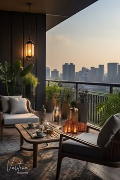 a balcony with two chairs and a coffee table on it, overlooking the city skyline