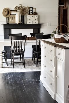 a dining room table and chairs in front of a fireplace