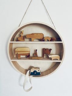 wooden toys are arranged in a circular shelf