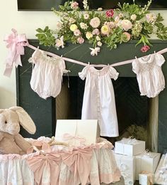 a teddy bear sitting in front of a baby's crib with flowers on it