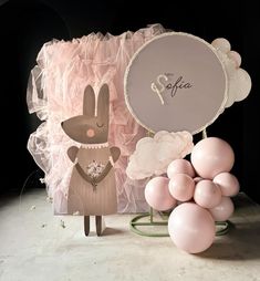 an image of a table setting with pink balloons and bunny figurines on it