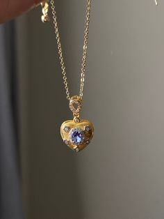 Discover the serene allure of our Tanzanite Heart Pendant, a jewel that transcends beauty with its therapeutic radiance. Tanzanite is known for its ability to elevate mood and promote inner peace, and our pendant, featuring this calming stone at its core, is a testament to tranquility. Encased in an 18k gold-plated sterling silver heart, each tanzanite is carefully chosen for its depth of color and clarity, offering not just a piece of jewelry but a source of comfort and healing. Wear it as a daily reminder of balance and calm in your journey through life. Ship from: California Measurement：14*14MM Materials:tanzanite,18K gold, sterling silver PLEASE NOTE:each pieces are unique. Please Follow our social media @ Ulovecreations  to see more video and updates Tanzanite Birthstone Necklaces For Anniversary, Tanzanite Pendant Necklace For Anniversary, Anniversary Tanzanite Pendant Necklace, Gold Tanzanite Pendant Jewelry, Gold Tanzanite Pendant Necklace, Heart Cut Tanzanite Jewelry Gift, Yellow Gold Tanzanite Necklace For Anniversary, Gold Tanzanite Necklace For Anniversary, Heart Shape Necklace