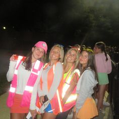 four girls in neon vests posing for the camera