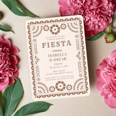 pink flowers and green leaves surrounding a wedding card with the word fiesta written on it