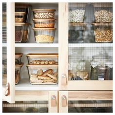 an open cabinet filled with lots of food and storage containers on top of it's sides