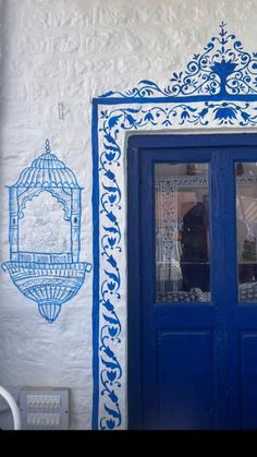 a blue and white building with two doors