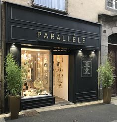 a store front with plants in the window