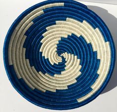 a blue and white basket sitting on top of a table